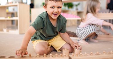 Un-nino-trabajando-con-material-Montessori-min